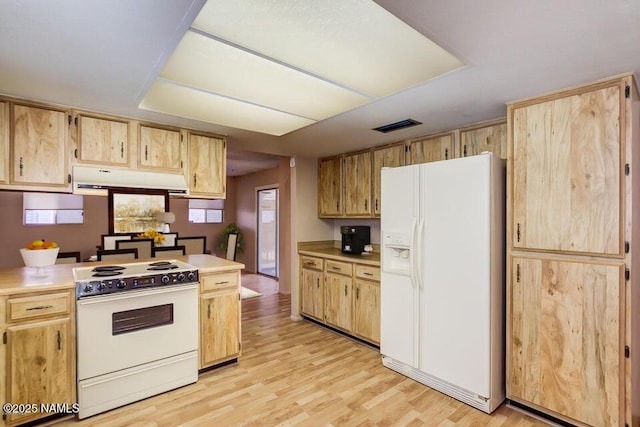 kitchen featuring visible vents, under cabinet range hood, light countertops, light wood-style floors, and white appliances