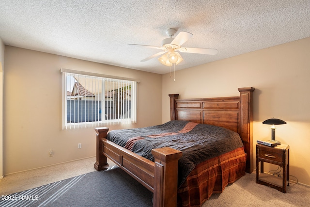 bedroom with carpet, a ceiling fan, and a textured ceiling