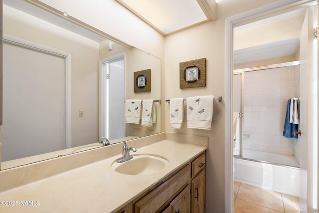 bathroom featuring enclosed tub / shower combo, vanity, and tile patterned flooring
