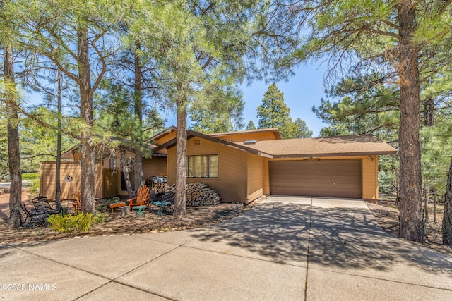 view of front of home with a garage and concrete driveway