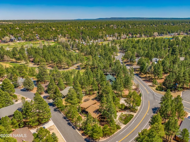 drone / aerial view featuring a residential view and a forest view