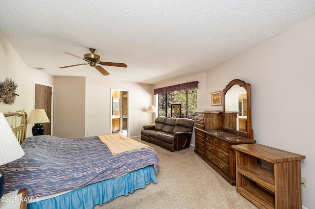 bedroom featuring visible vents, ceiling fan, a textured ceiling, carpet flooring, and ensuite bath