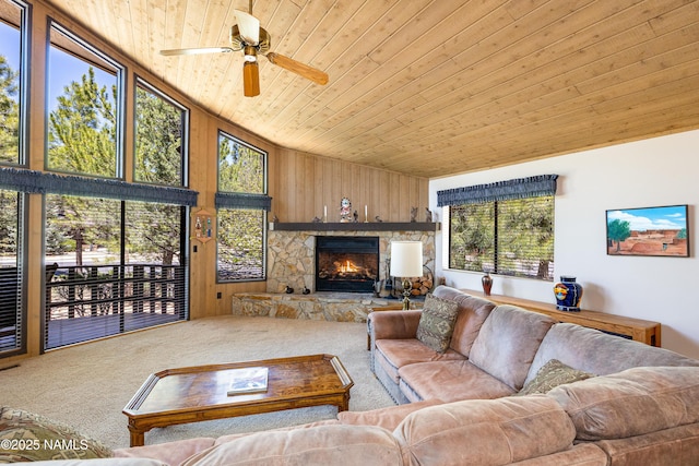 carpeted living area with ceiling fan, vaulted ceiling, wooden ceiling, and plenty of natural light