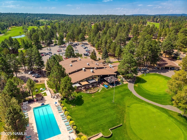 bird's eye view featuring golf course view and a forest view