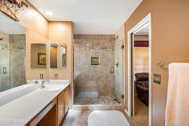 full bath with vanity and a stall shower