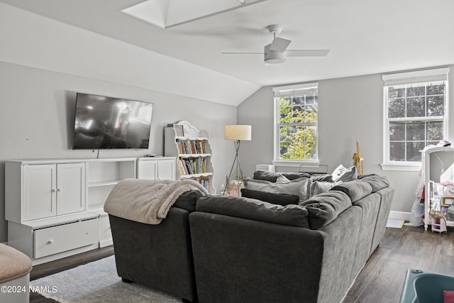 living room with ceiling fan, dark hardwood / wood-style flooring, and vaulted ceiling