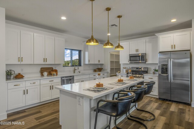 7939 N Red Lake Rd, Williams, AZ 86046 - kitchen with stainless steel appliances, white cabinets, recessed lighting, a center island, and light countertops
