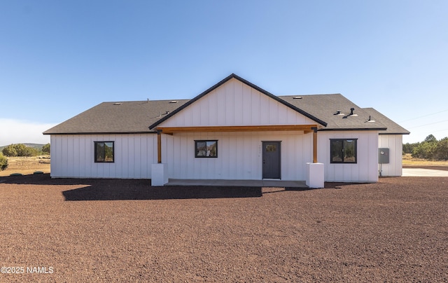 7939 N Red Lake Rd, Williams, AZ 86046 - back of property featuring board and batten siding and a shingled roof