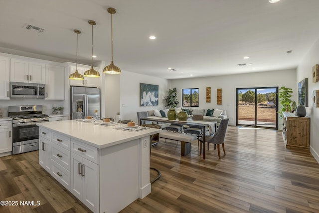 7939 N Red Lake Rd, Williams, AZ 86046 - kitchen with stainless steel appliances, open floor plan, white cabinets, a kitchen island, and light countertops