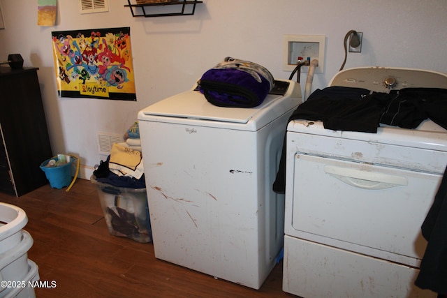 washroom with dark wood-type flooring and washing machine and clothes dryer