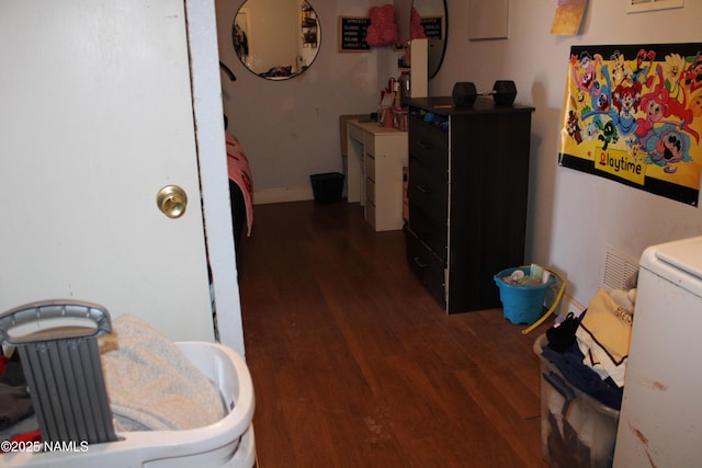 hallway featuring dark wood-type flooring and washer / clothes dryer