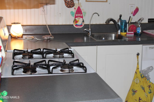 kitchen featuring white cabinetry and sink