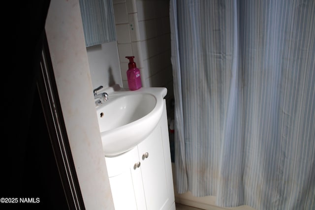 bathroom with vanity and shower / tub combo with curtain