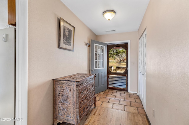 11095 N Rodeo Rd, Flagstaff, AZ 86004 - doorway to outside with visible vents and light wood-style flooring