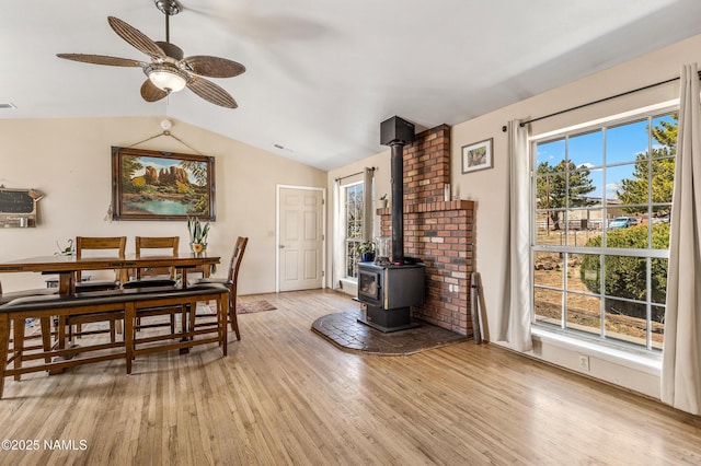 11095 N Rodeo Rd, Flagstaff, AZ 86004 - dining space with a wood stove, ceiling fan, light wood-type flooring, visible vents, and lofted ceiling