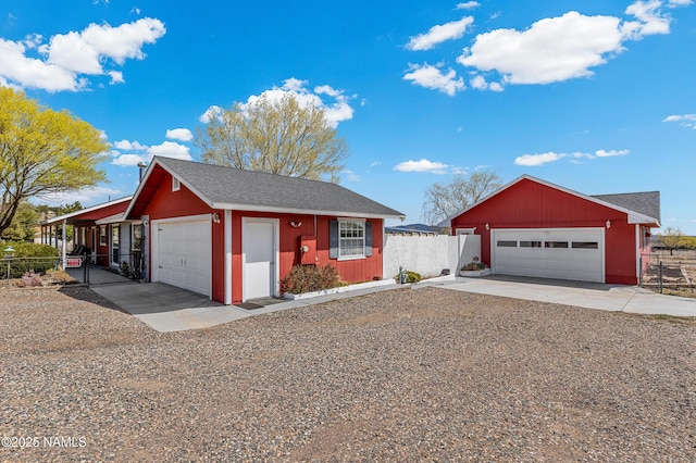 11095 N Rodeo Rd, Flagstaff, AZ 86004 - ranch-style house featuring a shingled roof, fence, and a detached garage