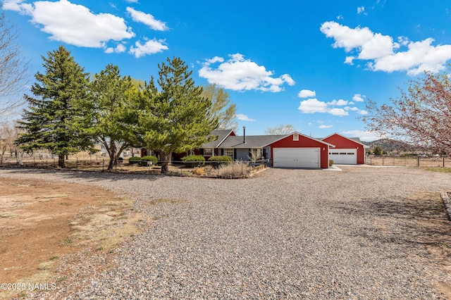 11095 N Rodeo Rd, Flagstaff, AZ 86004 - single story home with fence, a garage, and gravel driveway