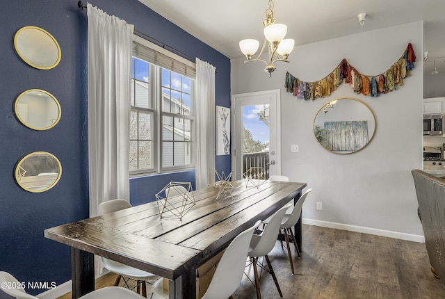 dining space with a chandelier, baseboards, wood finished floors, and a healthy amount of sunlight