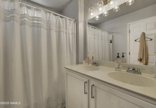 full bathroom with double vanity and a sink
