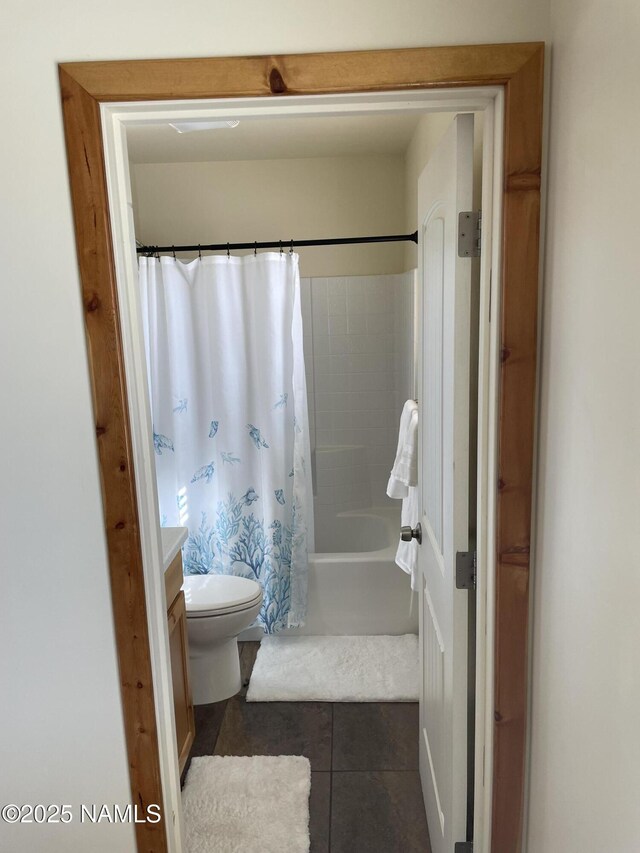 full bathroom with shower / bath combo with shower curtain, toilet, tile patterned floors, and vanity