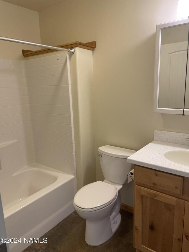 full bathroom with tile patterned floors, toilet, vanity, and shower / washtub combination