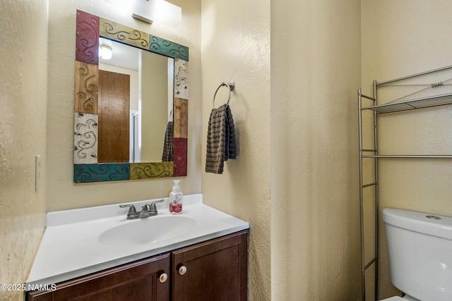 bathroom with toilet and vanity