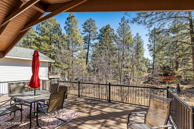 wooden deck featuring outdoor dining area