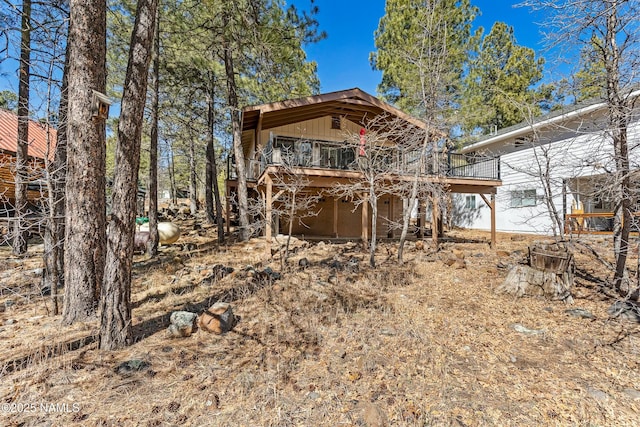 back of house featuring a deck