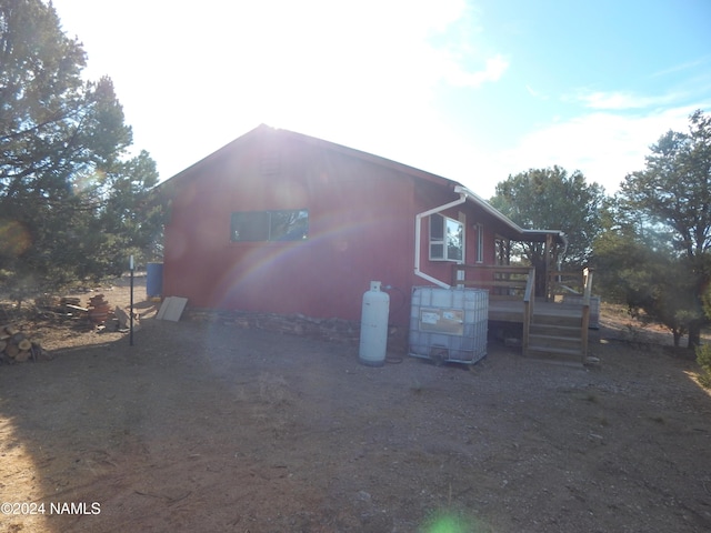 view of side of home with a deck