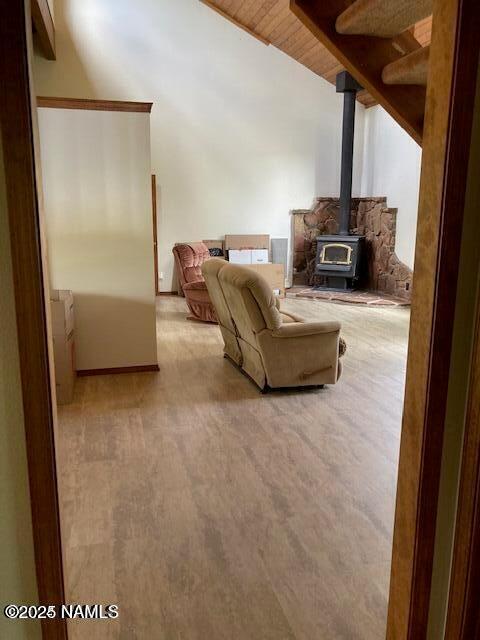 8355 N Stony Mountain Way, Flagstaff, AZ 86001 - carpeted living room with a wood stove, wooden ceiling, and lofted ceiling