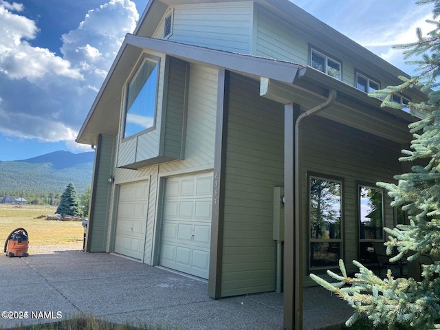 8355 N Stony Mountain Way, Flagstaff, AZ 86001 - view of side of home featuring a mountain view, an attached garage, and asphalt driveway