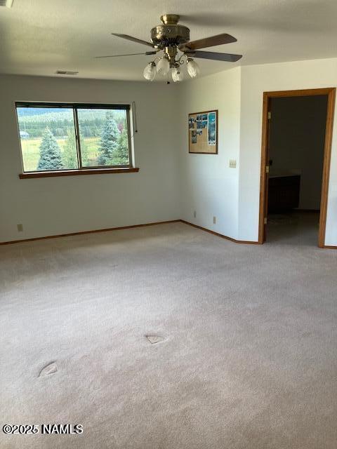 8355 N Stony Mountain Way, Flagstaff, AZ 86001 - spare room with carpet flooring, healthy amount of natural light, baseboards, and a ceiling fan