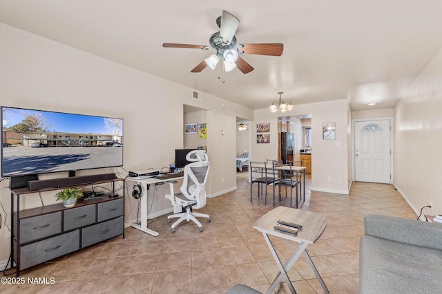 tiled office space with ceiling fan with notable chandelier