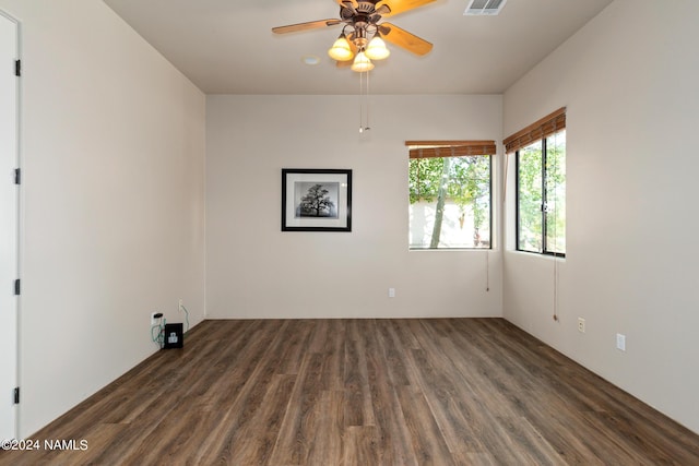 empty room featuring ceiling fan and dark hardwood / wood-style flooring