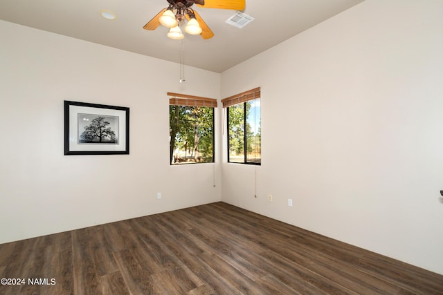 empty room featuring ceiling fan and dark wood-type flooring