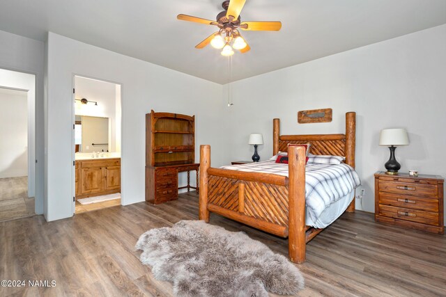 bedroom with ceiling fan, sink, wood-type flooring, and ensuite bathroom