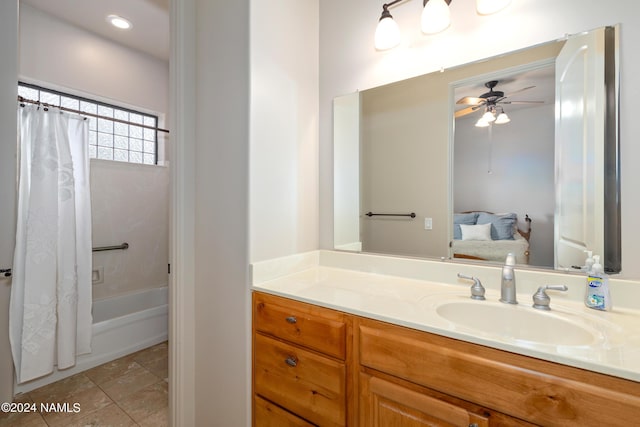 bathroom with shower / bath combo, ceiling fan, and vanity