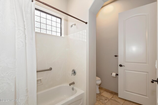 bathroom featuring toilet, tile patterned floors, and shower / bath combo