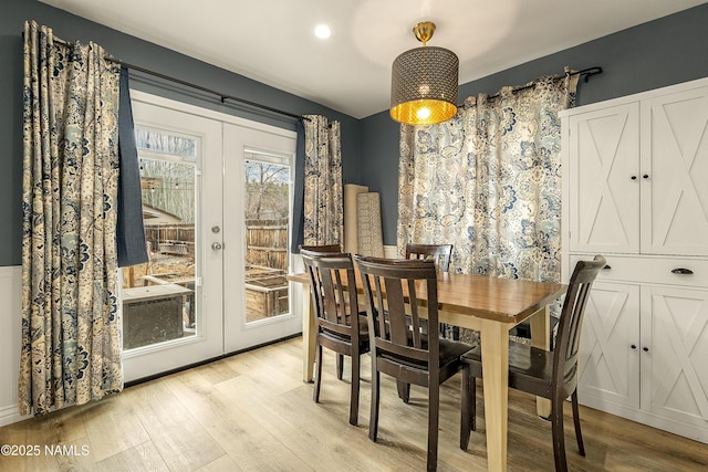 dining room featuring french doors and light wood-type flooring