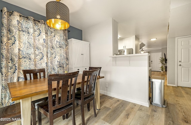 dining area featuring light wood-type flooring