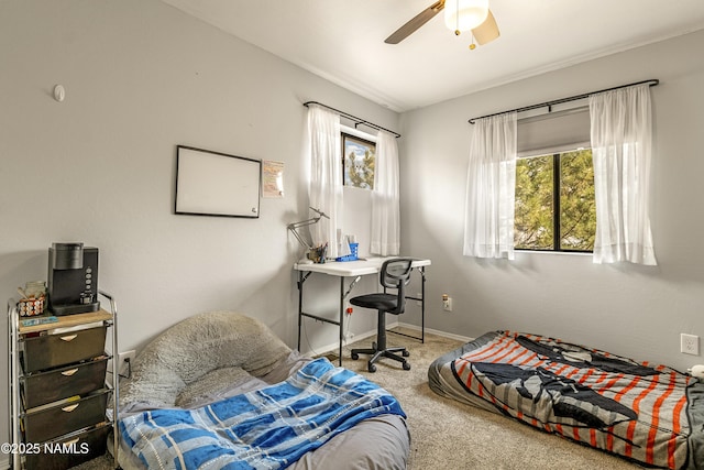 bedroom featuring multiple windows, ceiling fan, and carpet flooring