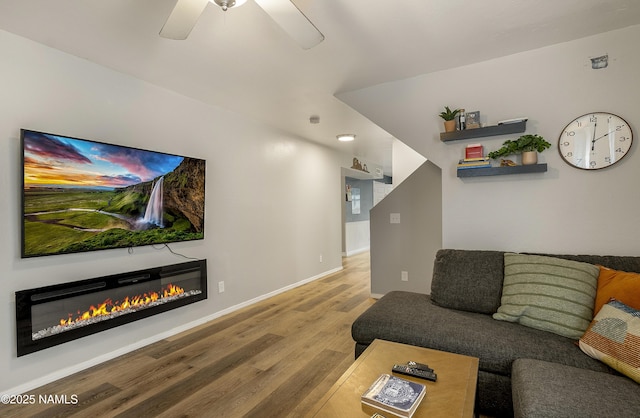 living room featuring ceiling fan and wood-type flooring