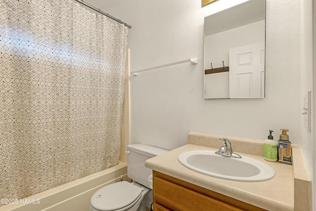 full bathroom with vanity, shower / tub combo, and toilet