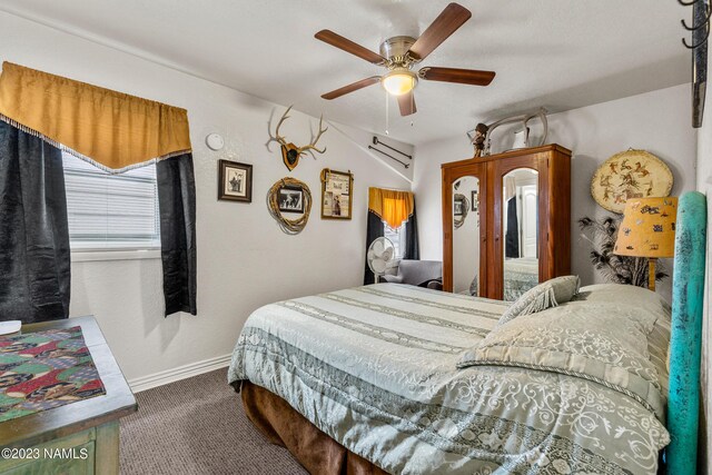 bedroom with dark carpet and ceiling fan