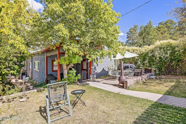 exterior space featuring a patio and a front lawn