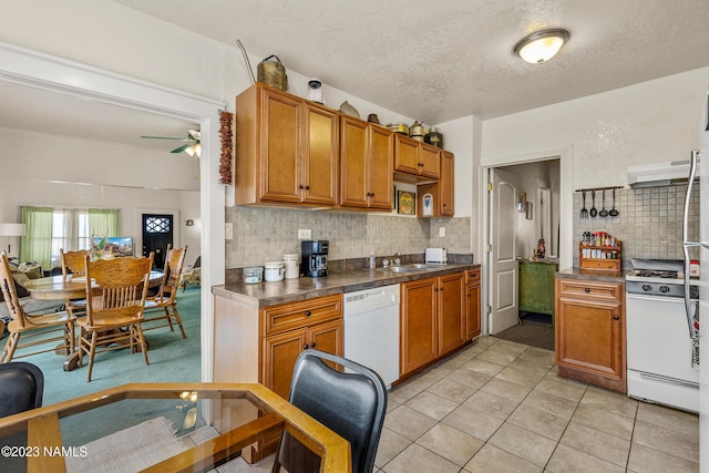 kitchen with white appliances, a textured ceiling, decorative backsplash, ceiling fan, and light tile patterned flooring