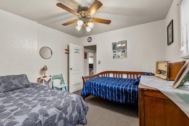 carpeted bedroom with a textured ceiling and ceiling fan