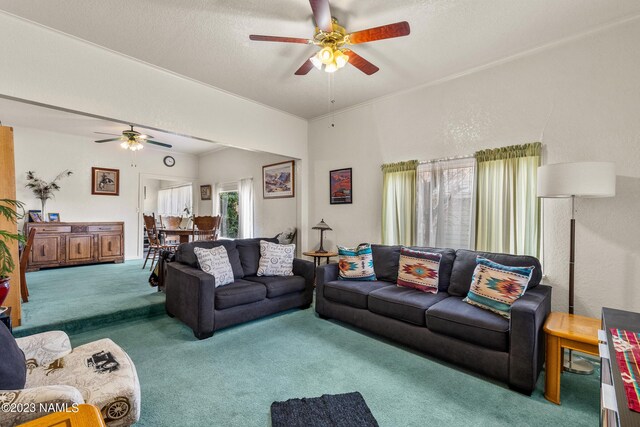 carpeted living room with a textured ceiling and ceiling fan