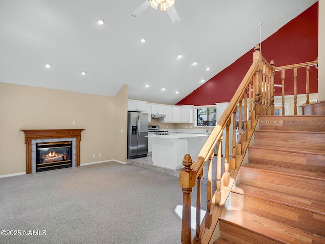 3792 E Ramble Wood Dr, Flagstaff, AZ 86004 - stairway with baseboards, carpet flooring, a fireplace, and a ceiling fan