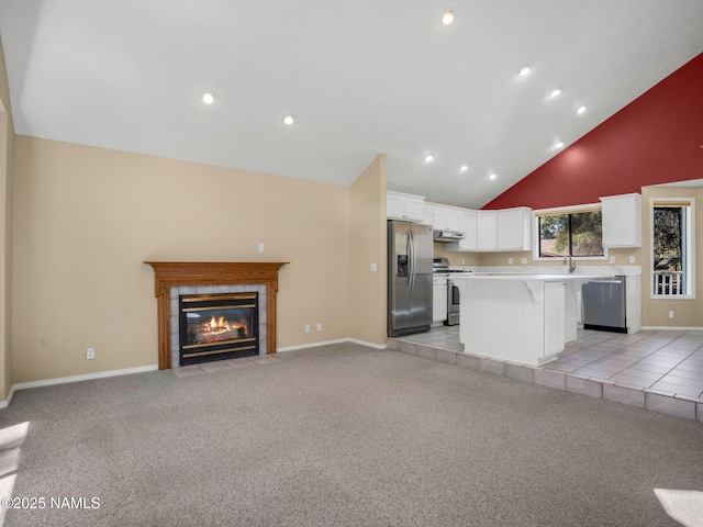 3792 E Ramble Wood Dr, Flagstaff, AZ 86004 - unfurnished living room with high vaulted ceiling, baseboards, a fireplace, recessed lighting, and light colored carpet